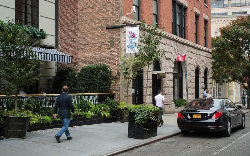 54 Thompson Street street level - the historic granite base and arched entrances with active street life